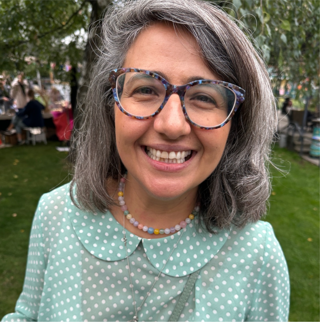 handmade colourful stone necklace of jade, agate and quartz on a smiling woman in a park