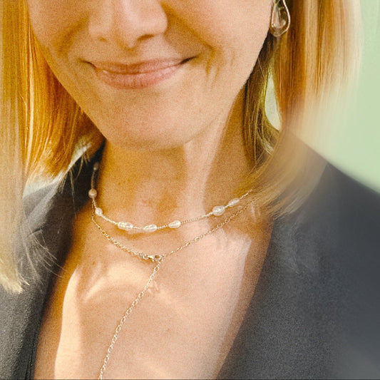 Woman with blonde hair and a gray blazer against a blurred background