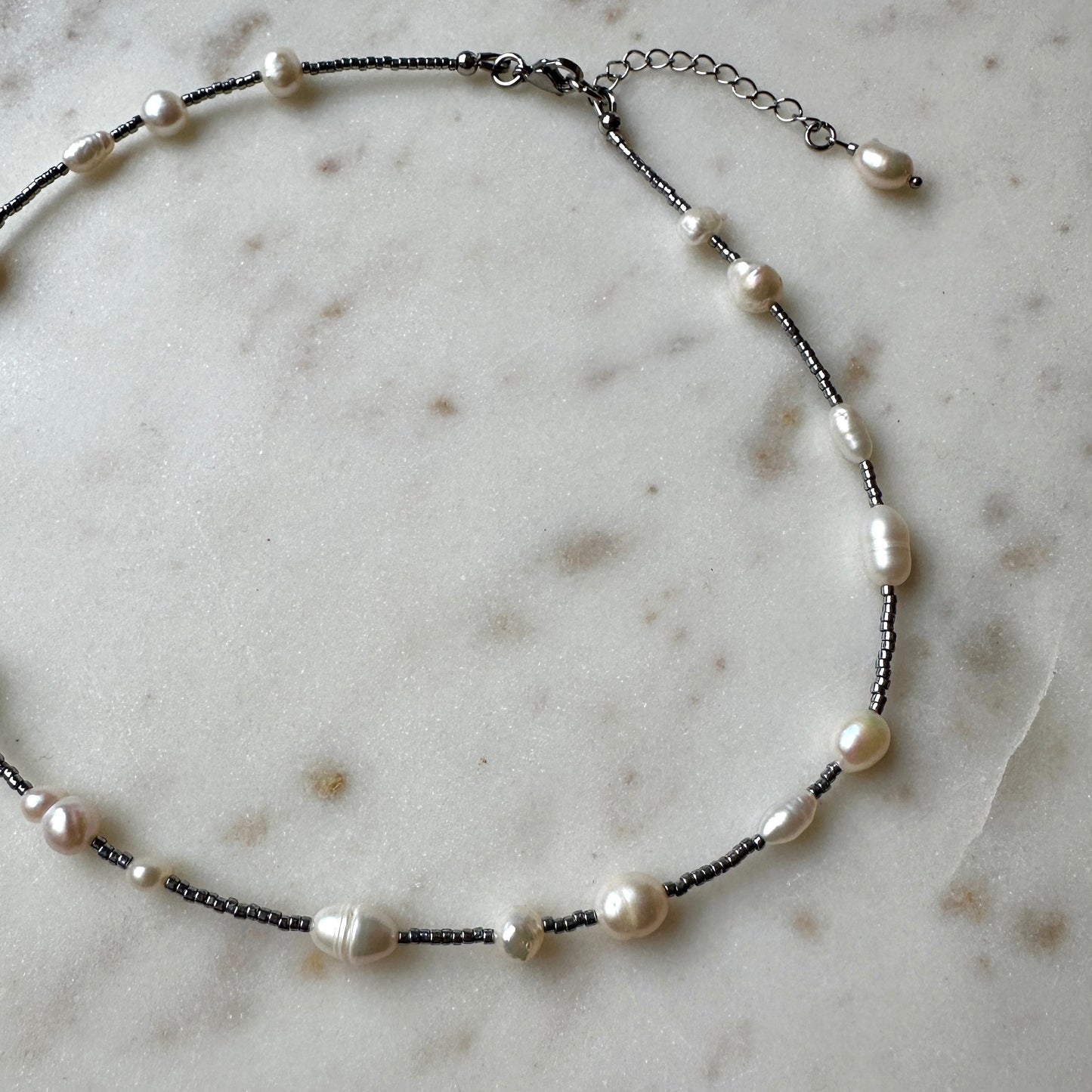 Pearl necklace on a marble surface