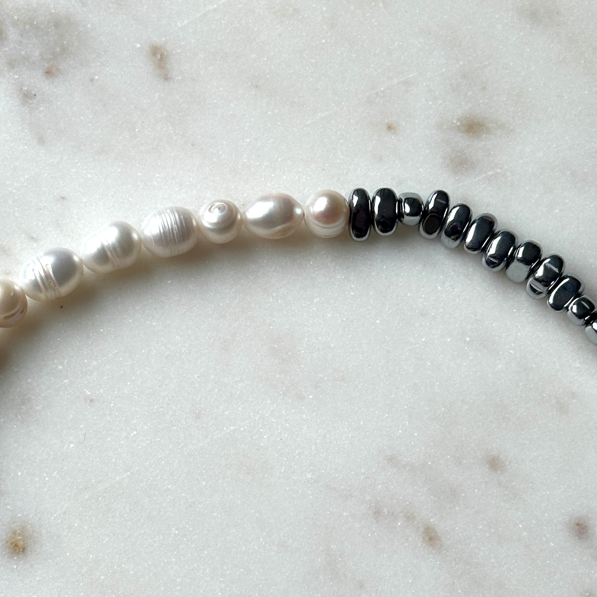 Handmade pearl necklace half with silver-plated hematite stones.