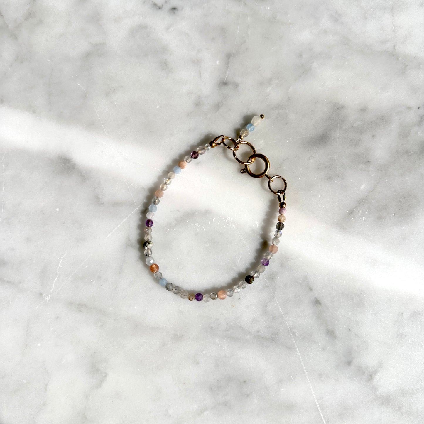 Multicolored beaded bracelet on a marble surface