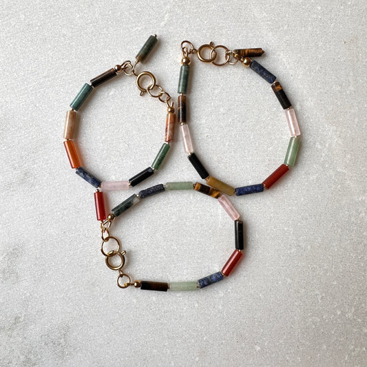 Multicolored stone beaded bracelet on a light gray background