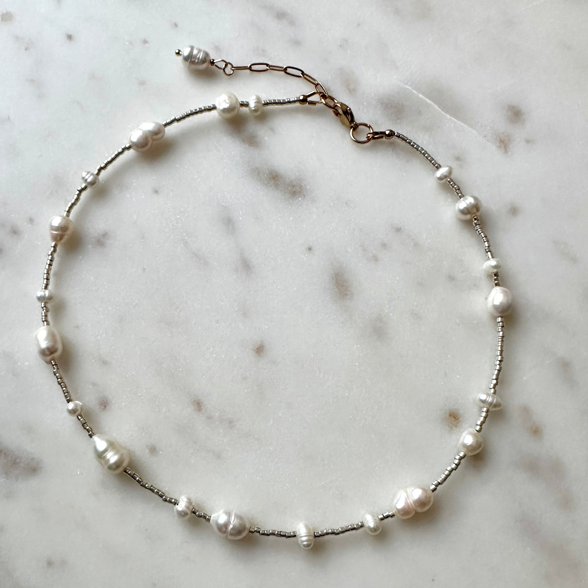 Pearl necklace on a marble surface