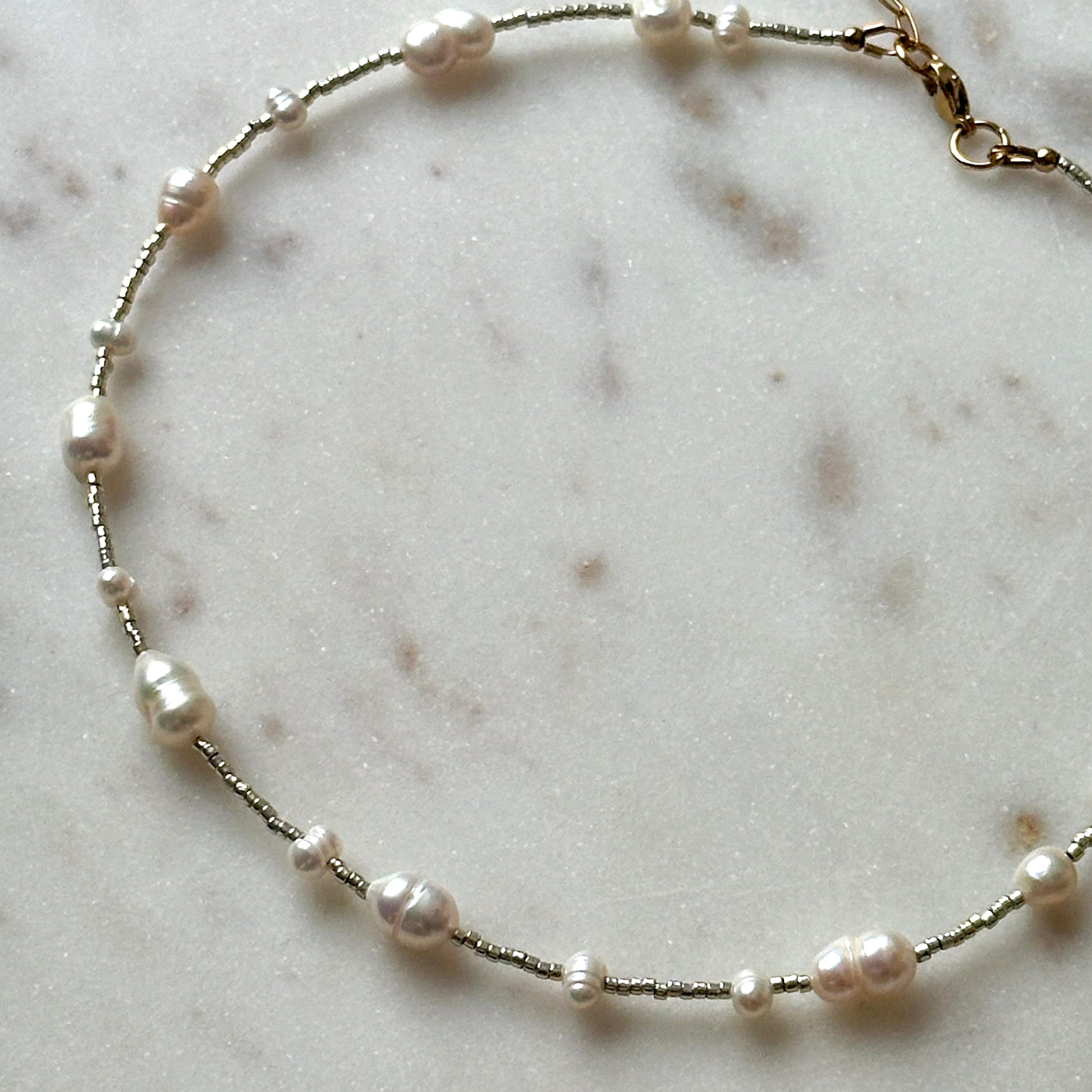 Pearl necklace on a marble surface