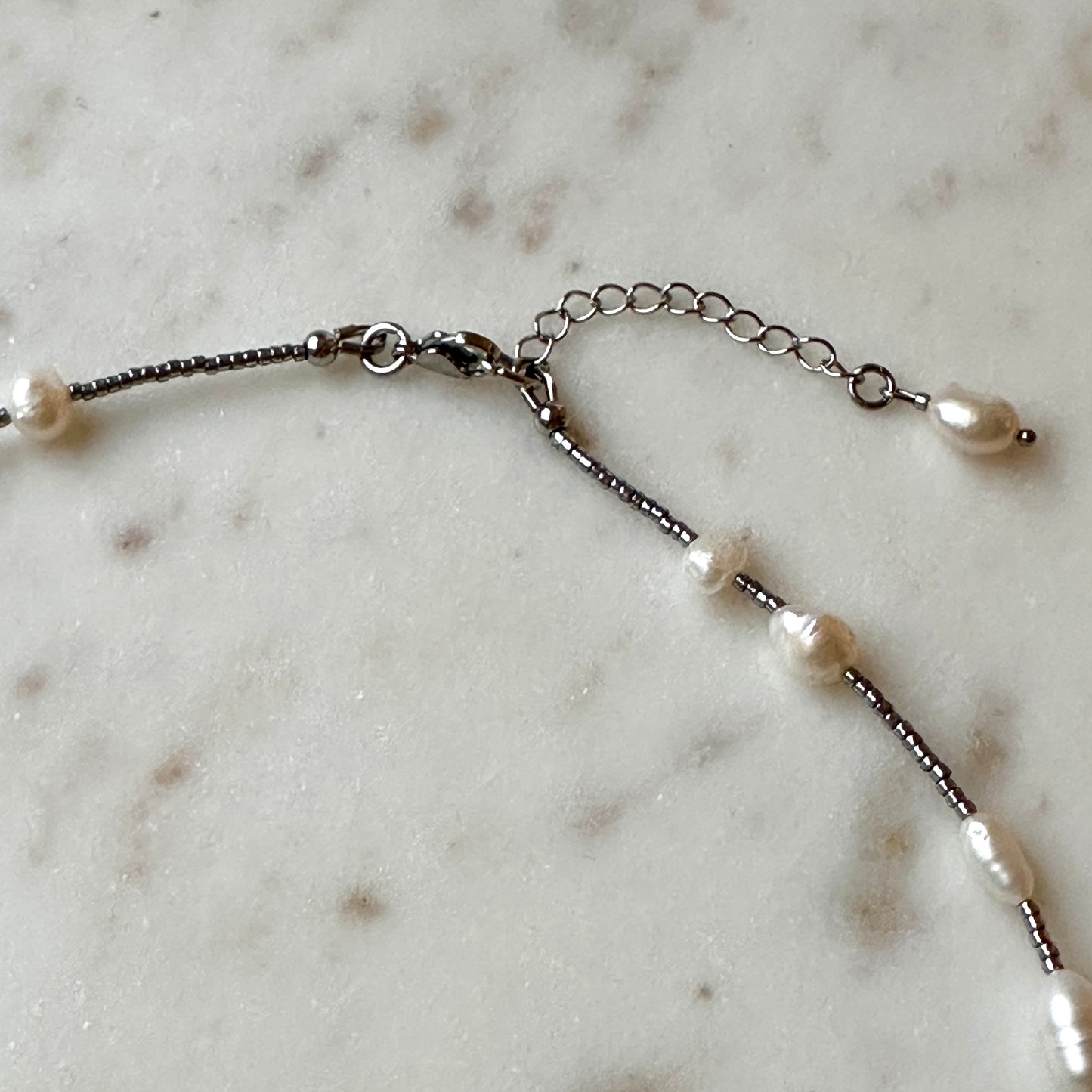 Pearl necklace on a marble surface
