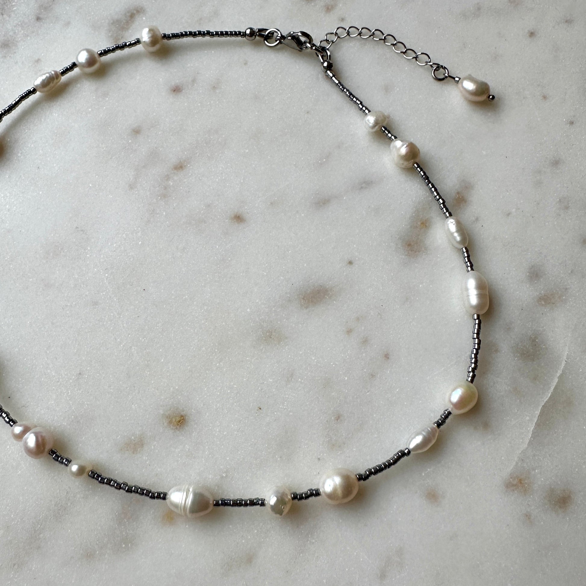 Pearl necklace on a marble surface