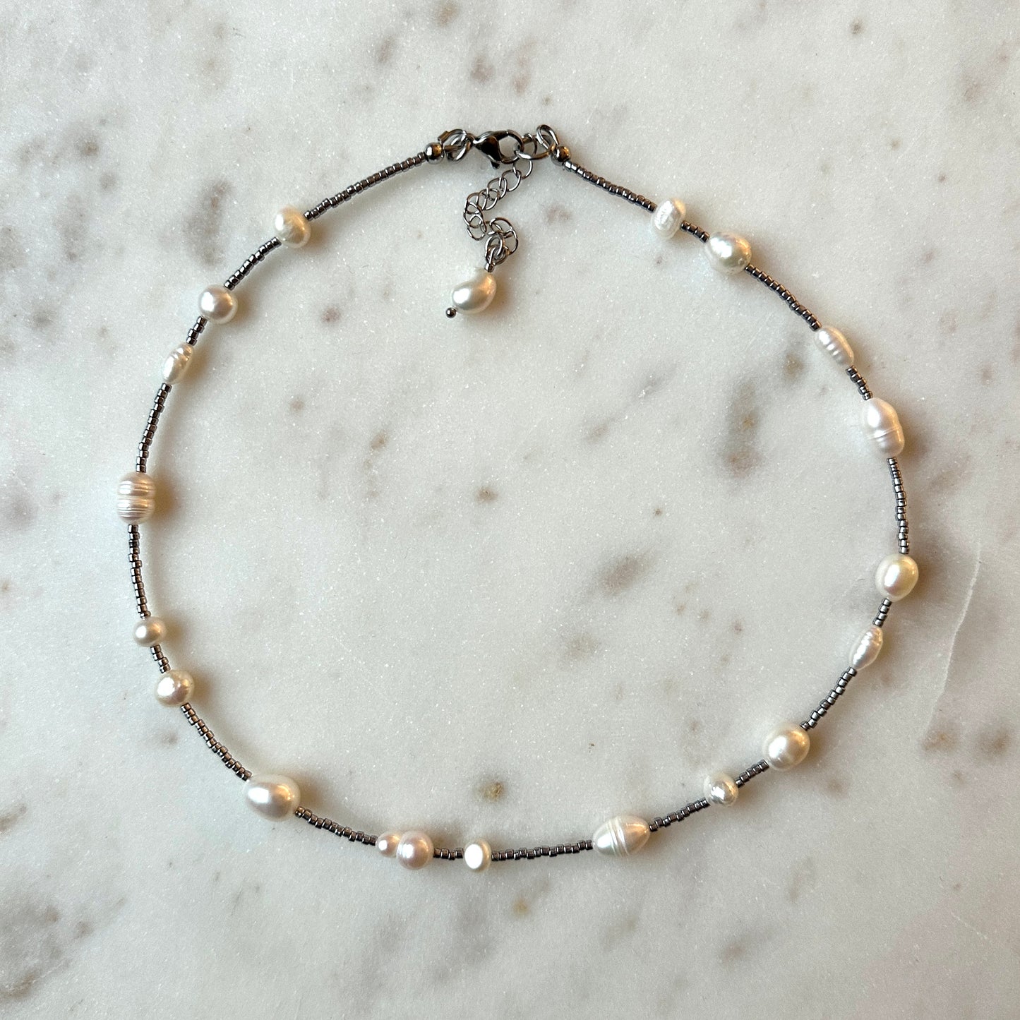 Necklace with pearls on a marble surface
