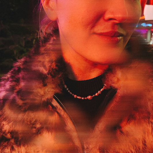 Close-up of a person wearing a fur-lined coat with a blurred background